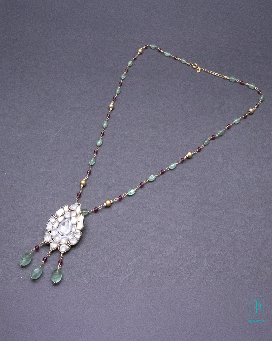 Necklace with decorative pendant on a gray background